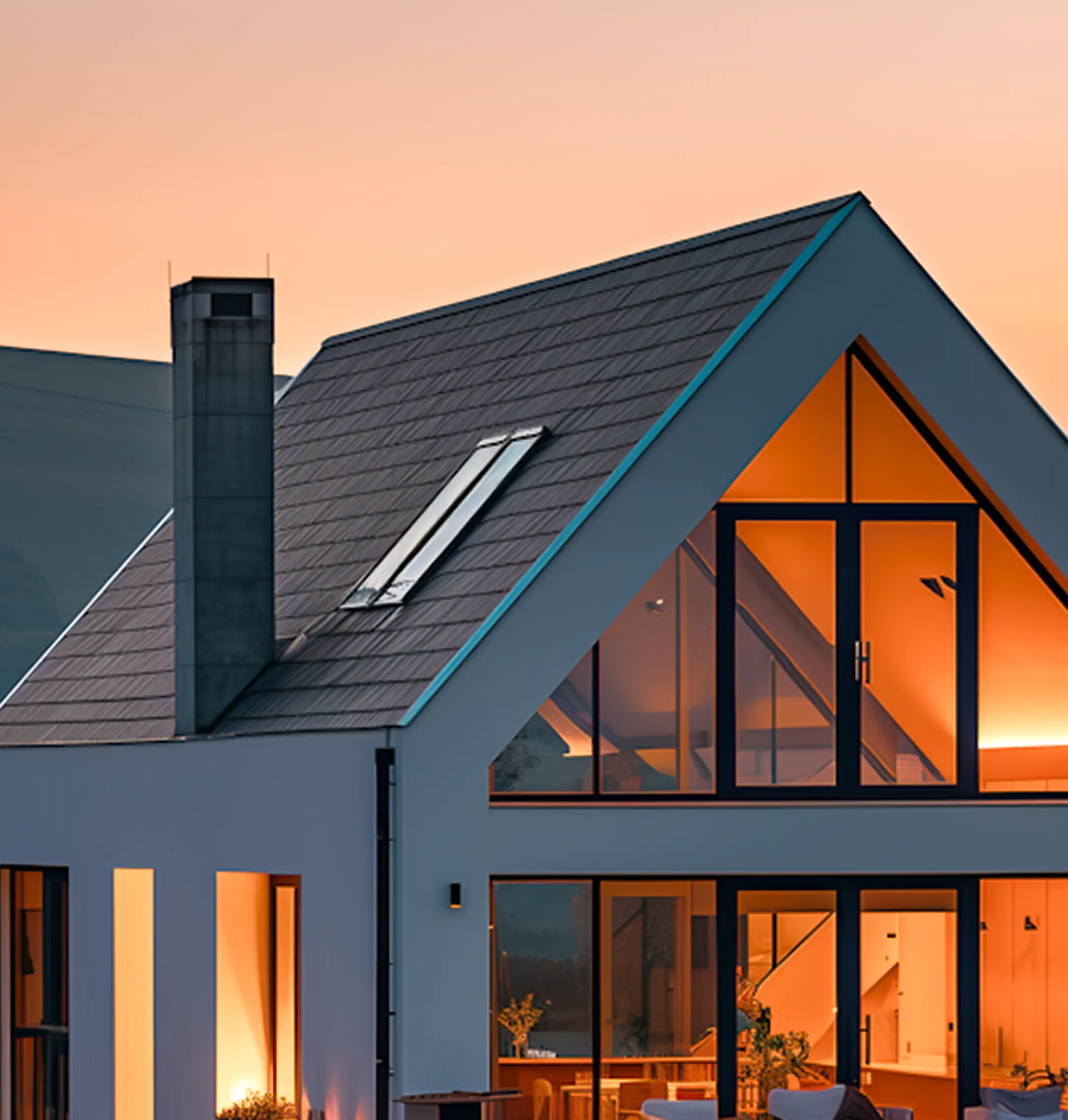 A finished house lit up at dusk